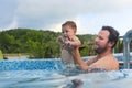 Father teaching small child swimming in the pool Royalty Free Stock Photo