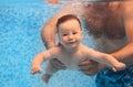 Father teaching small child swimming underwater in the pool Royalty Free Stock Photo