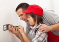 Father teaching son the basics of electrical work around the house