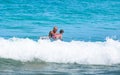 Father teaching son how to surfing.