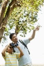 Father teaching son how to use binoculars. Conceptual image