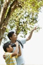 Father teaching son how to use binoculars. Conceptual image