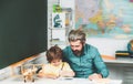 Father teaching son. Learning concept. Pupil learning letters and numbers. Supporting pupils at school. Royalty Free Stock Photo