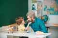 Father teaching son. Supporting pupils at school. Education background. Elementary school tutorship. Funny little child Royalty Free Stock Photo