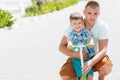 Father teaching son to ride a scooter Royalty Free Stock Photo