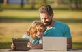 Father teaching son to use laptop, dad and school boy child looking computer screen and tablet, playing game, watching Royalty Free Stock Photo