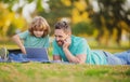 Father teaching son to use laptop dad and school boy child looking computer screen and tablet, playing game, watching Royalty Free Stock Photo