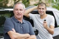 father teaching teenage son to drive