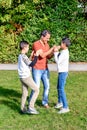 Father and teenage children in walking the park