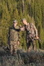 Father and son hunting together in woods Royalty Free Stock Photo