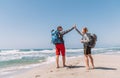 Father and teenager son with backpacks making High FIVE on sandy seaside beach during Lycian Way trekking walk. Famous Likya Yolu Royalty Free Stock Photo