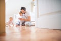 Father and toddler children with smartphone at home at bedtime. Royalty Free Stock Photo