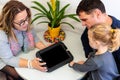 Father and toddler daughter in therapist office during counselling meeting.