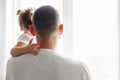 Father with toddler girl daughter looking into window waiting expecting see off someone. Child staring watching from home outside Royalty Free Stock Photo