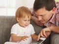 Father and toddler looking at book