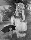 Father and toddler playing with hose outside Royalty Free Stock Photo