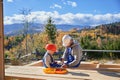 Father with toddler son building wooden frame house. Royalty Free Stock Photo