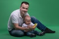 Father and toddler son playing with toy cell phone Royalty Free Stock Photo