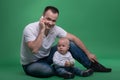 Father and toddler son playing with toy cell phone Royalty Free Stock Photo