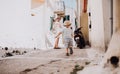 A father with toddler son walking in town on summer holiday.