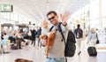 Father traveling with child, holding his infant baby boy at airport terminal waiting to board a plane waving goodby Royalty Free Stock Photo