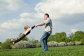 Father twirling his little son Royalty Free Stock Photo