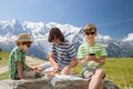 The father and two boys have got picnic in mountains Royalty Free Stock Photo