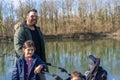 Father with two children is walking along the Aare river in springtime Royalty Free Stock Photo