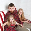 Father with two daughters cuddling