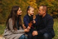 Father and two daughters in the forest. Autumn weather and colorful background. Happy family. Two sister show their love Royalty Free Stock Photo