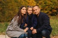 Father and two daughters in the forest. Autumn weather and colorful background. Happy family. Two sister show their love Royalty Free Stock Photo