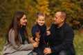 Father and two daughters in the forest. Autumn weather and colorful background. Happy family. Two sister show their love Royalty Free Stock Photo