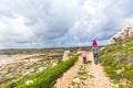 Father and two daughters walk along the path along the sea. Beautiful valley by the sea. Seascape in Cyprus Ayia Napa Royalty Free Stock Photo