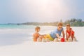 Father and kids making sand castle at tropical beach. Family playing with beach toys Royalty Free Stock Photo