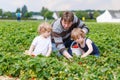 Father and two little boys on organic strawberry farm Royalty Free Stock Photo