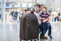 Father and two little sibling boys at the airport Royalty Free Stock Photo