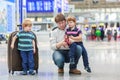 Father and two little sibling boys at the airport Royalty Free Stock Photo