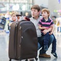 Father and two little sibling boys at the airport Royalty Free Stock Photo