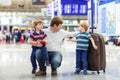 Father and two little sibling boys at the airport Royalty Free Stock Photo