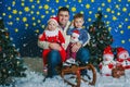 Father with two small boys riding on the sled