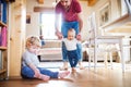 Father with two toddlers at home. First steps.