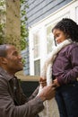 Father tying daughters scarf