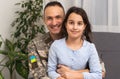 Father in Ukrainian military uniform and his daughter. Family reunion