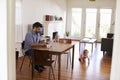 Father Uses Laptop Whilst Baby Son Plays On Floor Royalty Free Stock Photo