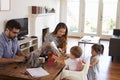 Father Uses Laptop Whilst Mother Plays With Children At Home Royalty Free Stock Photo