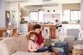 Father using computer with son, family in background Royalty Free Stock Photo