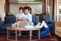 Father using a laptop at home with children. A happy dad online with his a and daughter. Young man with a little boy and Royalty Free Stock Photo