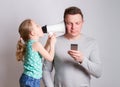 Father using smartphone ignoring his daughter Royalty Free Stock Photo