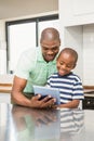 Father using tablet with his son Royalty Free Stock Photo