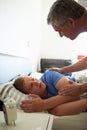 Father Waking Up Teenage Son Royalty Free Stock Photo